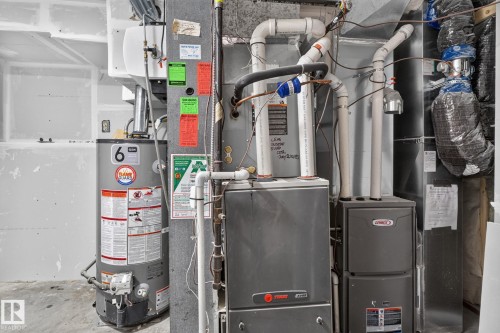 Modern mechanical systems including a water heater, furnace, and air handler - 9530 174 Avenue Nw, Edmonton, AB - Indoor Photo Showing Basement