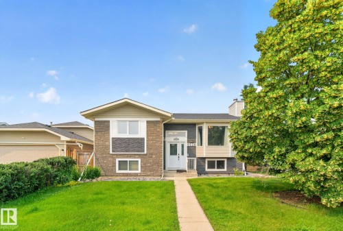 Split-level residence featuring stone and siding facade - 9530 174 Avenue Nw, Edmonton, AB - Outdoor With Facade