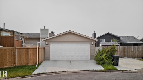 Attached two-car garage with a concrete driveway, complemented by light-colored siding and a contrasting dark roof - 9530 174 Avenue Nw, Edmonton, AB - Outdoor