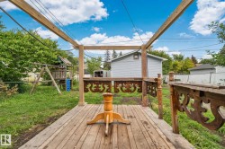 Wood-plank deck with decorative balusters and a partial pergola frame - 