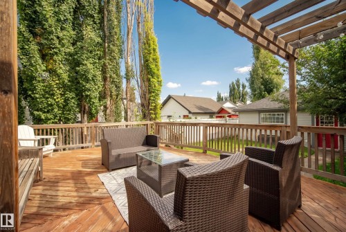 Expansive wooden deck with a slatted railing and integrated pergola - 1660 Tomlinson Common Nw, Edmonton, AB 