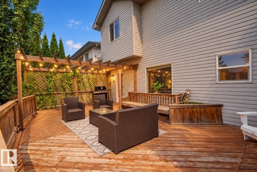 Expansive wood deck with a built-in pergola, privacy lattice, and integrated planter box - 1660 Tomlinson Common Nw, Edmonton, AB 