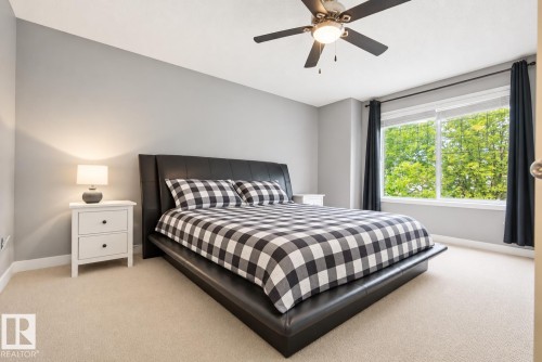 Recessed lighting, ceiling fan, expansive windows, carpeted flooring, and neutral wall paint - 1660 Tomlinson Common Nw, Edmonton, AB 
