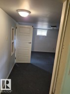 Carpeted flooring, paneled interior door, and a flush mount ceiling light fixture - 