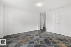 Multi-toned square tile flooring, built-in bi-fold closet doors, and flush-mount ceiling lighting - 