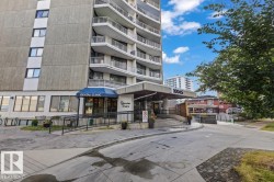 Multi-story building featuring a prominent entrance canopy, ground-level retail space, and a dedicated vehicle entrance - 