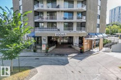 Multi-story building exterior with individual balconies, prominent building numbering, a covered entrance, and a sloped access ramp - 