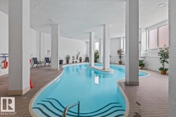 Indoor swimming pool with integrated steps and a surrounding tiled deck - 