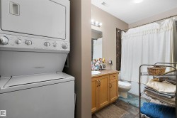 Compact laundry area featuring a stacked washer and dryer unit - 