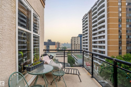 Private balcony featuring concrete flooring, a glass and metal railing system, and city skyline - #713 10503 98 Av Nw, Edmonton, AB - Outdoor With Balcony