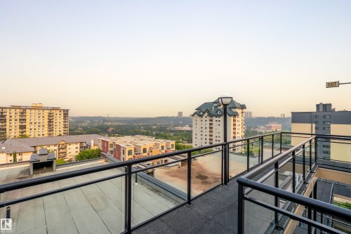 Rooftop walkway with black metal and glass panel railings - #713 10503 98 Av Nw, Edmonton, AB - Outdoor With Balcony With View