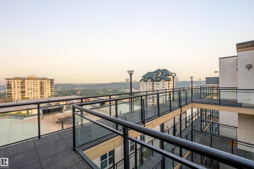 Rooftop walkway with glass and black metal railings - #713 10503 98 Av Nw, Edmonton, AB - Outdoor With Balcony With View