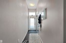 Entryway featuring a white door with upper window, dark wood-finish flooring, light grey painted walls, and a ceiling-mounted light fixture - #713 10503 98 Av Nw, Edmonton, AB  - Indoor Photo Showing Other Room 