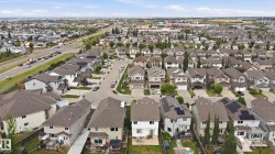 Residential development featuring multiple properties with shingled roofs - 