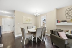 Dark wood-finish flooring throughout, white trim, and a built-in wall shelf - 