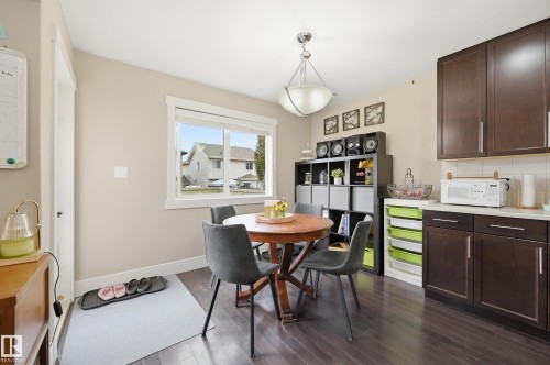 Dark wood-finish flooring with light wall tones and white trim - 1564 36 Avenue Nw, Edmonton, AB 