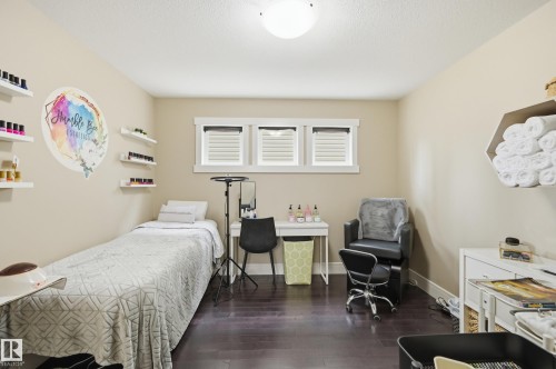 Dark wood-finish flooring with light-toned walls - 1564 36 Avenue Nw, Edmonton, AB 