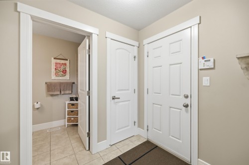Tile flooring, white paneled doors, and contemporary white trim - 1564 36 Avenue Nw, Edmonton, AB 