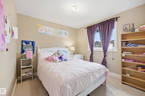 Recessed window with drapes, built-in shelving, and a neutral wall color - 1564 36 Avenue Nw, Edmonton, AB 