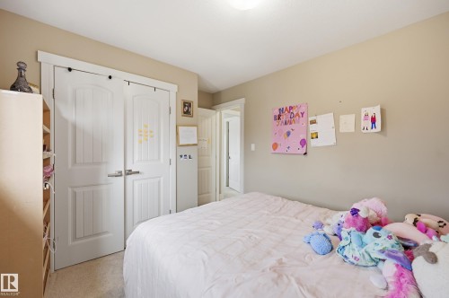 White paneled bi-fold closet doors with brushed nickel hardware - 1564 36 Avenue Nw, Edmonton, AB 