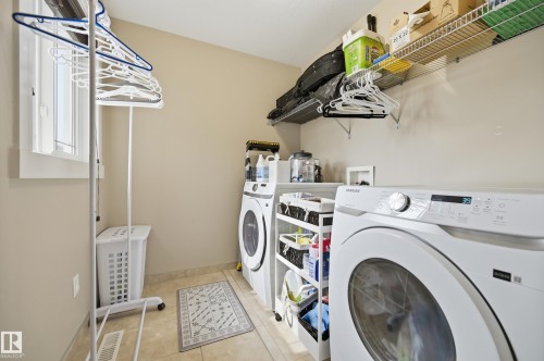 Laundry area with a window, tile flooring, and integrated wire shelving - 1564 36 Avenue Nw, Edmonton, AB 
