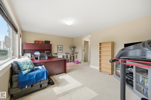 Large windows, wall-to-wall carpeting, recessed ceiling light, built-in shelving, and neutral wall tones - 1564 36 Avenue Nw, Edmonton, AB 