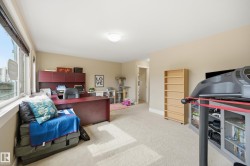 Large windows, wall-to-wall carpeting, recessed ceiling light, built-in shelving, and neutral wall tones - 