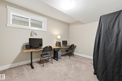 Recessed window with white trim, neutral-toned walls, and plush carpet flooring - 1564 36 Avenue Nw, Edmonton, AB 