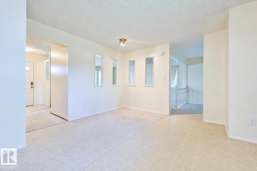 Expansive room featuring carpeted and tiled flooring, recessed wall shelving, and a ceiling-mounted light fixture - 9 Hawkins Crescent, Sherwood Park, AB 