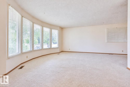 Expansive room featuring a curved wall of multiple windows, providing abundant natural light - 9 Hawkins Crescent, Sherwood Park, AB 