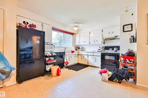 Kitchen featuring white cabinetry, a black appliance suite, a ceiling fan, and tile-finish flooring - 9 Hawkins Crescent, Sherwood Park, AB 
