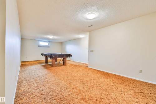 Recessed lighting fixtures, broadloom carpeting, and an egress window - 9 Hawkins Crescent, Sherwood Park, AB 
