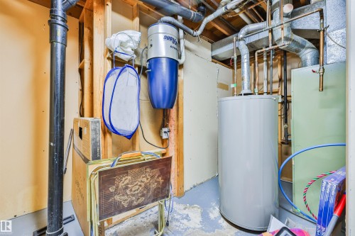 Central vacuum system, water heater, exposed utility piping, and structural framing - 9 Hawkins Crescent, Sherwood Park, AB 
