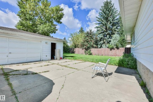 Detached garage with a roll-up door, a side entrance, and a concrete pad - 9 Hawkins Crescent, Sherwood Park, AB 