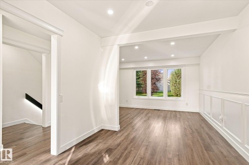 Recessed lighting, wood-finish flooring, white trim, multiple windows, and decorative wainscoting - 17325 85 Avenue Nw, Edmonton, AB 
