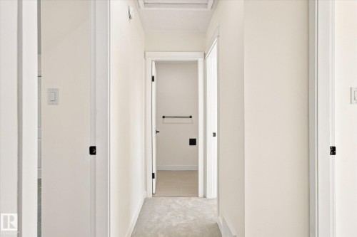 Hallway with neutral wall tones and light-colored carpeting - 17325 85 Avenue Nw, Edmonton, AB 