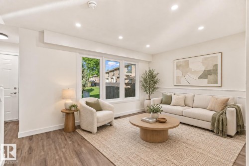 Recessed ceiling lighting, wood-finish flooring, large multi-pane window, decorative wall molding, and white interior doors - 17325 85 Avenue Nw, Edmonton, AB 