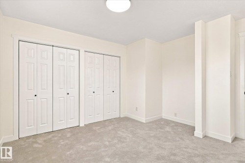 Neutral wall finishes, plush carpet flooring, recessed ceiling lighting, and multiple bi-fold closet doors - 17325 85 Avenue Nw, Edmonton, AB 