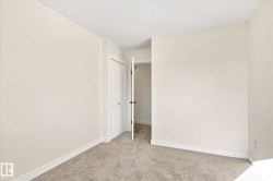 Neutral-toned walls and carpeted flooring - 
