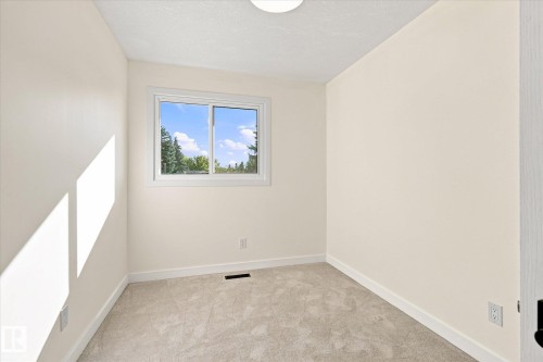 Neutral tone wall paint, light-toned carpet flooring, white trim detailing, and a single window - 17325 85 Avenue Nw, Edmonton, AB 
