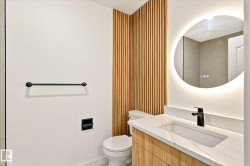 Modern vanity with wood-finish cabinetry, integrated rectangular sink, and light-toned countertop - 