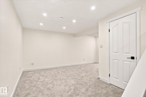 Recessed ceiling lighting, light gray carpet, white interior door with black hardware, and light-toned walls - 17325 85 Avenue Nw, Edmonton, AB 