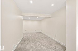 Recessed lighting, light gray carpeting, and neutral wall paint - 