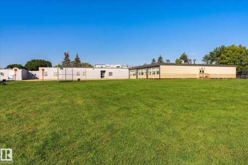 Expansive green space featuring a large building with multiple windows - 17325 85 Avenue Nw, Edmonton, AB 