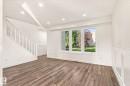 Wood-finish flooring throughout, bright white walls, recessed ceiling lighting, triple-pane windows, and wainscoting detail - 17325 85 Avenue Nw, Edmonton, AB 