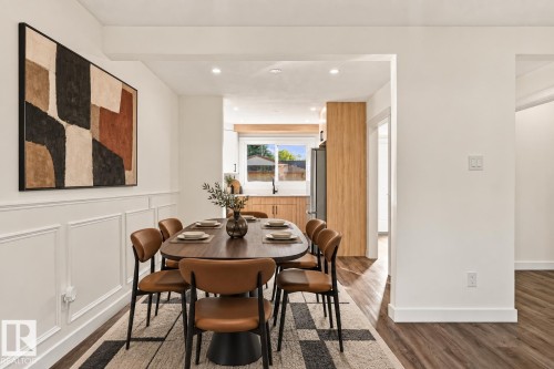 Dining area featuring wainscoting and wood-finish flooring - 17325 85 Avenue Nw, Edmonton, AB 
