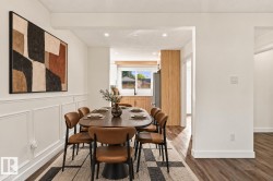 Dining area featuring wainscoting and wood-finish flooring - 
