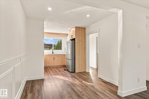 Wood-finish flooring, recessed lighting, and white wainscoting - 17325 85 Avenue Nw, Edmonton, AB 