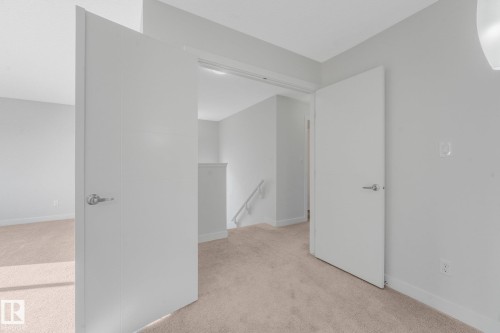 Light grey walls with neutral carpet flooring and white trim - 7832 Erasmus Wynd Nw, Edmonton, AB 