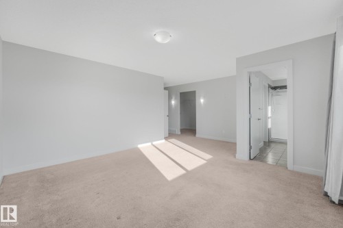 Neutral wall tones, recessed lighting, and carpeted flooring - 7832 Erasmus Wynd Nw, Edmonton, AB 